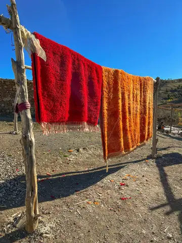 Traditional Moroccan rugs displayed in the Atlas Mountains