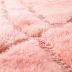Pink and yellow rug with carved diamond motifs, handwoven in natural wool by Moroccan artisans.